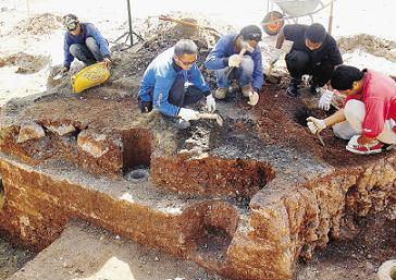 Image: Workers from the Malacca Museums Corporation and National Heritage Department painstakingly uncovering the ancient wall."