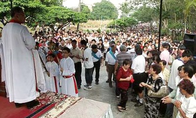 Image: Rev. Fr. Moses Lui presiding over the religious service in front of the chapel."