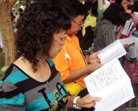 Image: Christians following the religious service with the use of prayer books."