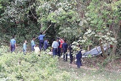 Image: Police personnel inspecting the wreckage of the RMAF Pilatus PC-7 after it crashed behind the Bukit Tangga Malaysian Agricultural Research and Development Institute (Mardi) next to the UUM campus on Thursday."